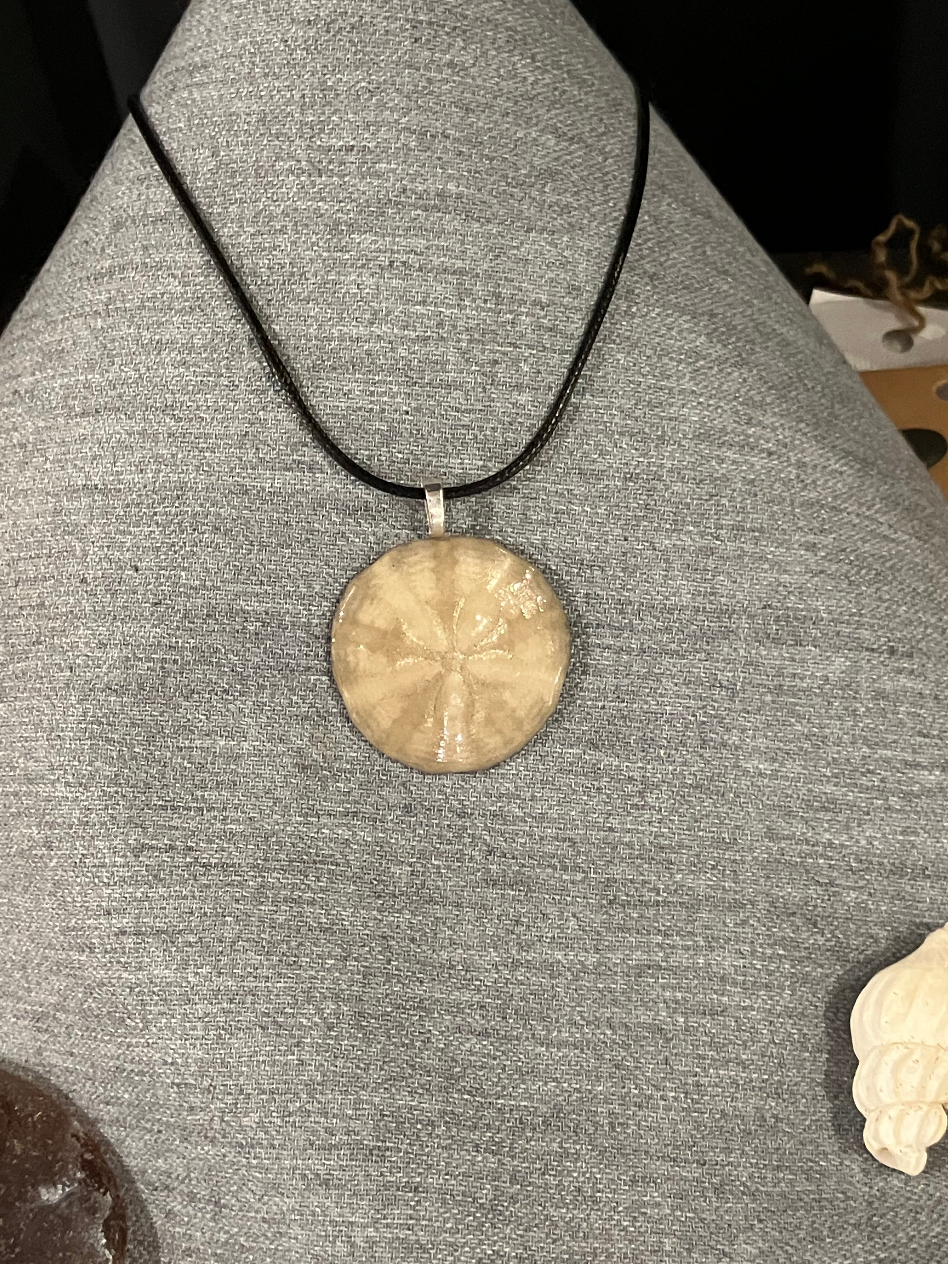 Sand dollar necklace on black cord