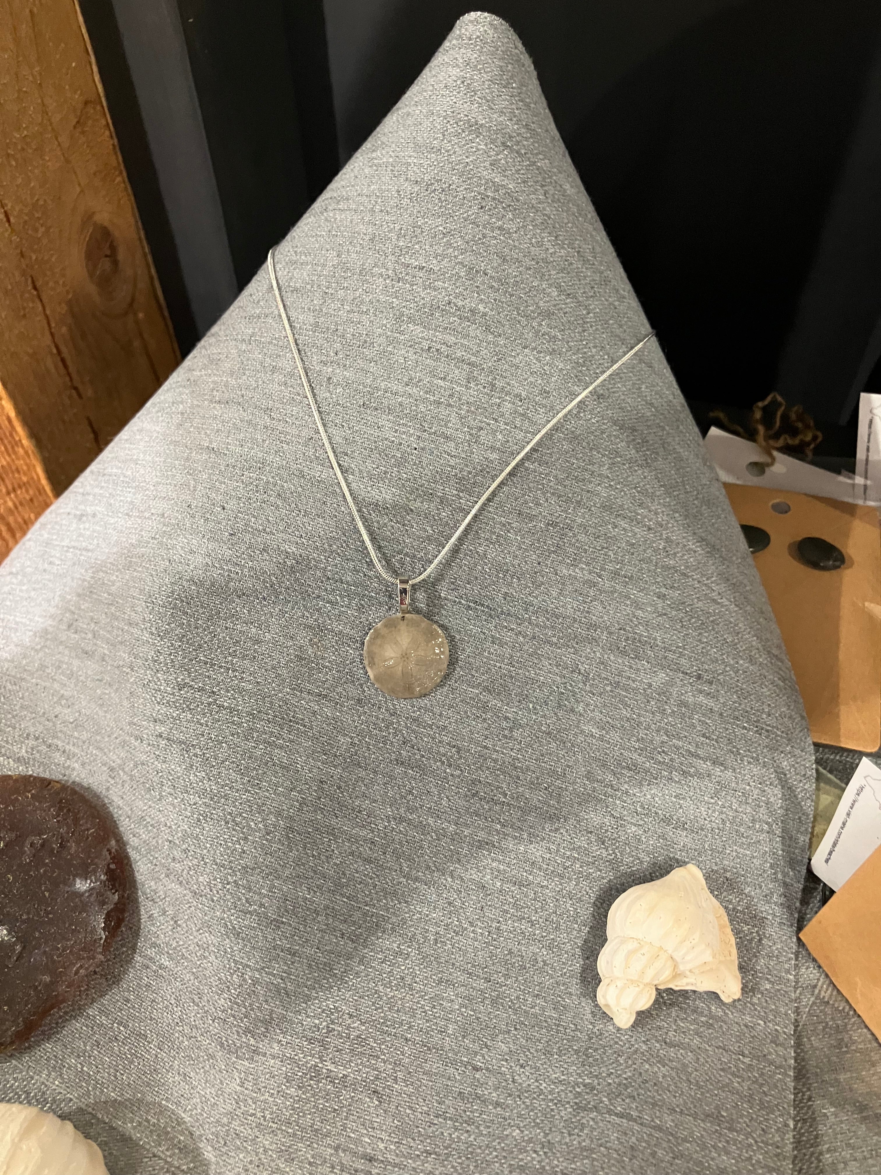 Sand dollar necklace on silver cord-tiny tan